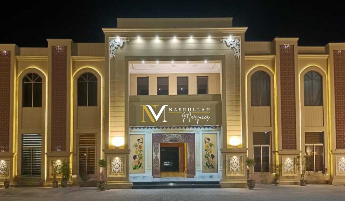 Night view of Nasrullah Marquees, a grand building with an illuminated exterior. The facade features large arched windows, decorative panels, and a central entrance adorned with floral artwork. The building's name is prominently displayed above the entrance in elegant lettering.